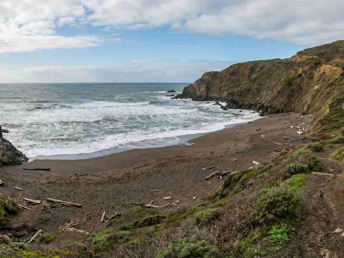 Tennessee Cove with black sand and shipwreck history